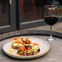 Bruschetta caponata with a glass of wine on the bar terrace